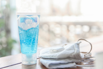 Prevention of medical face masks  and hand alcohol liquid gel for hand hygiene coronavirus protection on the table copy space for text.