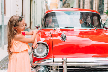Tourist girl in popular area in Havana, Cuba. Young kid traveler smiling