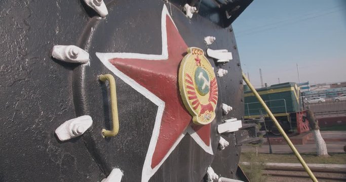 Old black steam locomotive train with a red star and coat of arms, emblem. Made in the Soviet Union USSR. Moving clip.