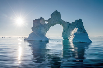 Iceberg during sunrise with backlight by sunrays. Disko Bay, Western Greenland. © Uryadnikov Sergey