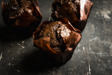 Homemade chocolate muffin on the rustic background. Selective focus. 