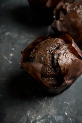 Homemade chocolate muffin on the rustic background. Selective focus. 