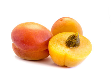 Two whole apricots and a sliced ​​apricot isolated on white background