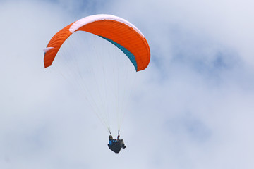 Paraglider flying wing in a blue sky	