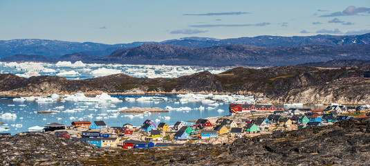 View from a nearby hill, overlooking the town of Illulisat, West Greenland .