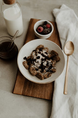 Healthy breakfast ingredients for a balanced diet with fresh fruit, rolled oat, honey, raisin and vegan almond milk