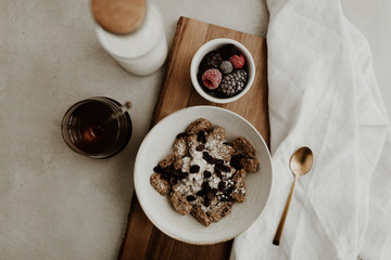 Healthy breakfast ingredients for a balanced diet with fresh fruit, rolled oat, honey, raisin and vegan almond milk