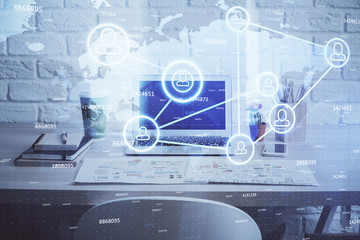 Computer on desktop with social network hologram. Multi exposure. Concept of international people...