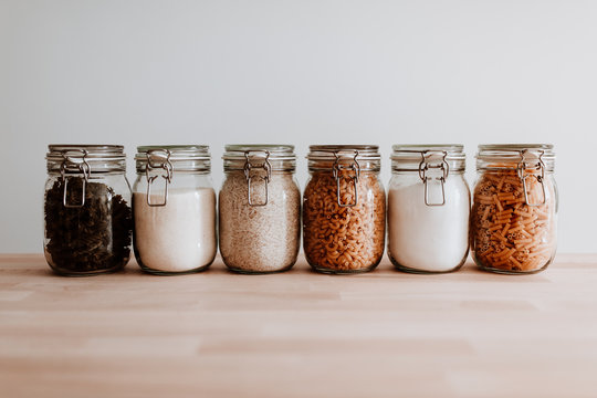 Six Glass Jars Full With Dried Uncooked Food Ingredients