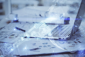 Computer on desktop in office with technology theme hologram. Multi exposure. Tech concept.