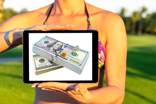 Make money online. Business concept with making profit using internet. Laptop computer with money in woman hands. Making money online concept. Using a laptop to building online business