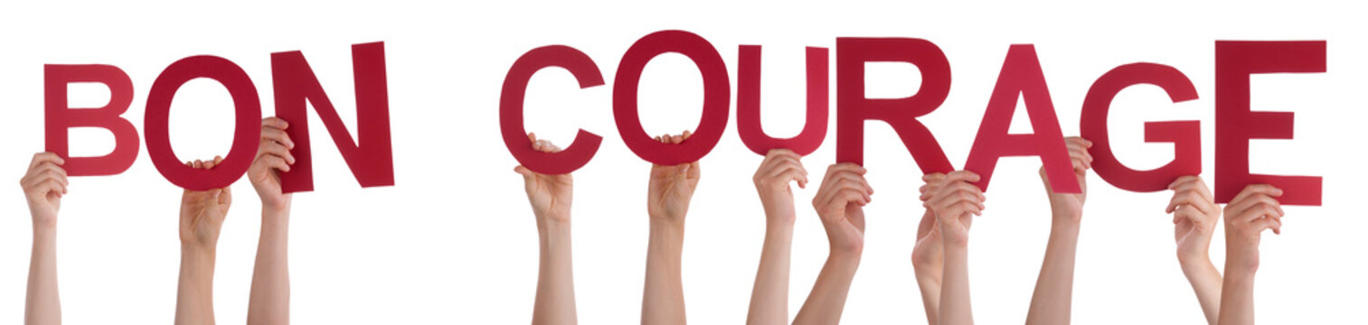 People Hands Holding Colorful French Word Bon Courage Means You Can Do It. White Isolated Background
