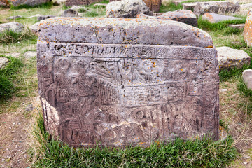 Noratus, Armenia-May, 01 2019: headstone with scene from life of Armenian family. Unique lagest cemetery of khachkars, Armenia