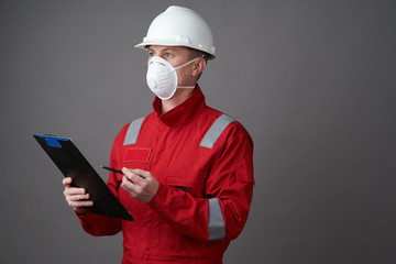 Man engineer, construction worker wearing face mask