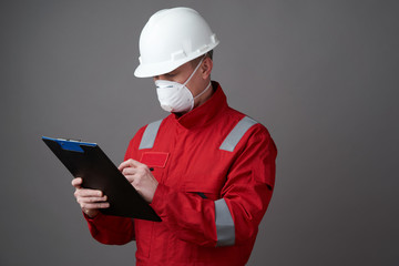 Man engineer, construction worker wearing face mask