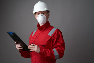 Man engineer, construction worker wearing face mask