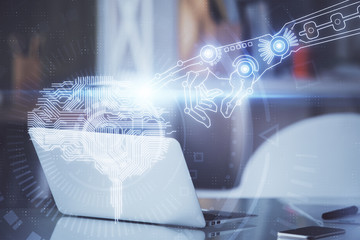 Double exposure of table with computer and brain hologram. Data innovation concept.