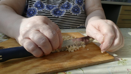 hands cutting bread with knife