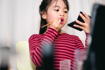 Asian Child Make up  Beauty blogger showing how to make up Video Tablet , Happy Asian girl vlogger...