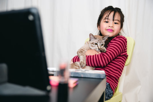 Asian Child Make up  Beauty blogger showing how to make up Video Tablet , Happy Asian girl vlogger With Cat
