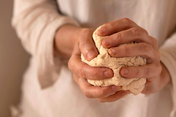Close-up of hands kneading bread dough