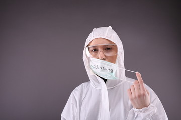 Woman in protective costume puts on a mask 