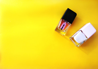 Group of two nail polishes, on yellow background