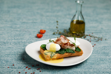 waffles with poached eggs and bacon