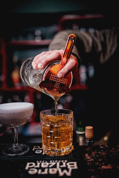  bartender pours a cocktail