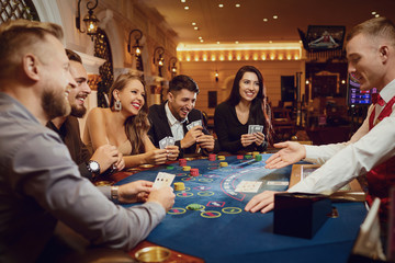 People gamble at a poker table in a casino