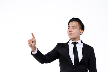 Young business man wearing black suit using finger on augmented reality touch screen against white background