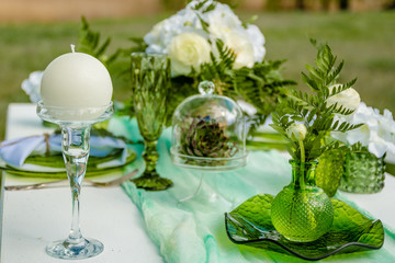 beautiful green dishes on a decorated table in the afternoon in the park