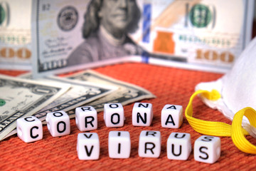 Text coronavirus word, white protective mask, american money dollars on a fabric  background.