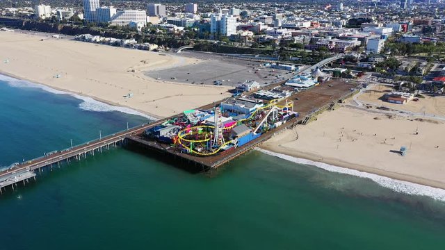 Aerial view of vacant Santa Monica pier with no people in Los Angeles California as result of  coronavirus pandemic or COVID-19 virus outbreak and lockdown