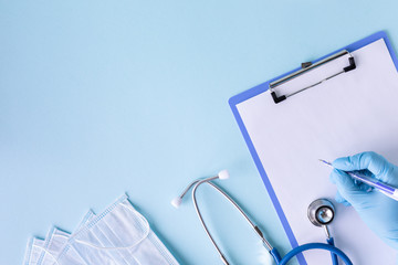 medical concept on a blue background. stethoscope, pills, tablet, notepad, sheet of paper, pen....