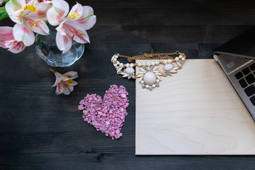 Valentine's day background-flowers, heart beads and laptop. mockup and place for your text