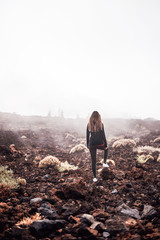 Young woman contemplating the fog on her way to Teide top in Tenerife, Spain