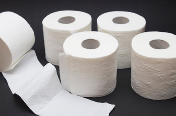 Toilet paper rolls close up on black background