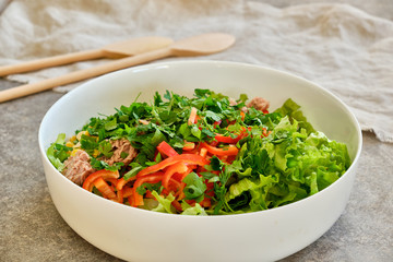 White plate with chopped vegetables and tuna