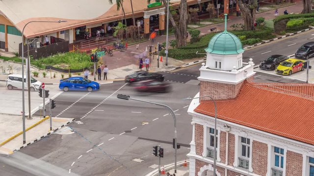 Aerial view of intersection and art deco shophouses with red roofs along Neil road in Chinatown area timelapse. Traffic on the street with crossroad and crossing