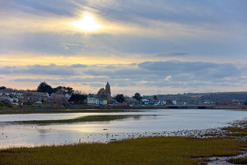 Hayle with the Parish of St Elwyn's Church across Copperhouse Creek at dusk, Cornwall, England, UK.
