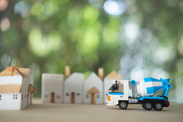 Blue cement mixer truck toy and wood home