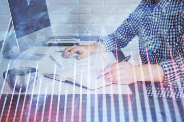 Double exposure of stock market chart with man working on computer on background. Concept of...