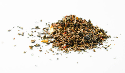 Black tea with bergamot and citrus leaves on a white background. Loose tea in a heap.  Copy Space