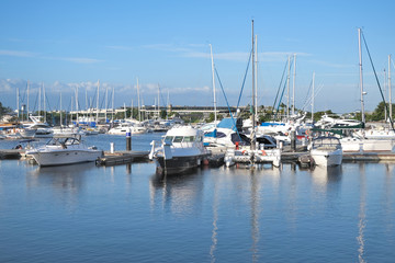 Many speed boats and yachts in the port in the bay.