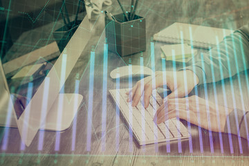 Double exposure of financial graph with man works in office on background. Concept of analysis.