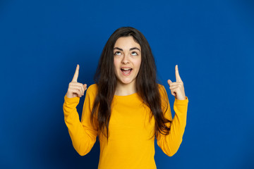 Brunette young girl wearing yellow jersey