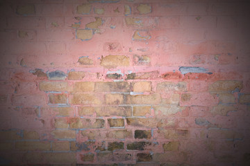 Dirty old pink painted brick wall with vignette effect