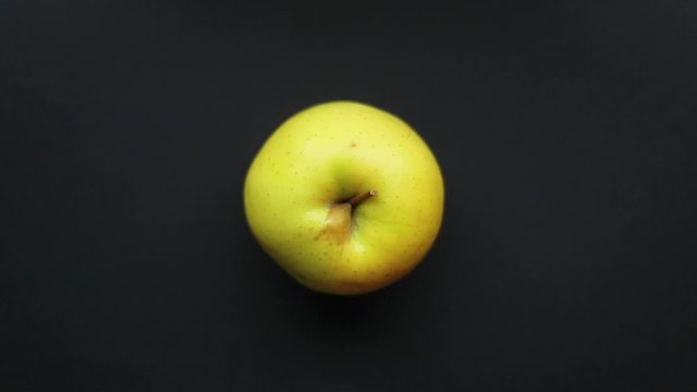 apple is placed on a black background to use as an example for a concept