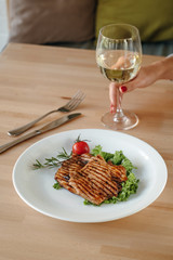 Chicken club sandwich with fries and vegetables on a white plate. Meal time.